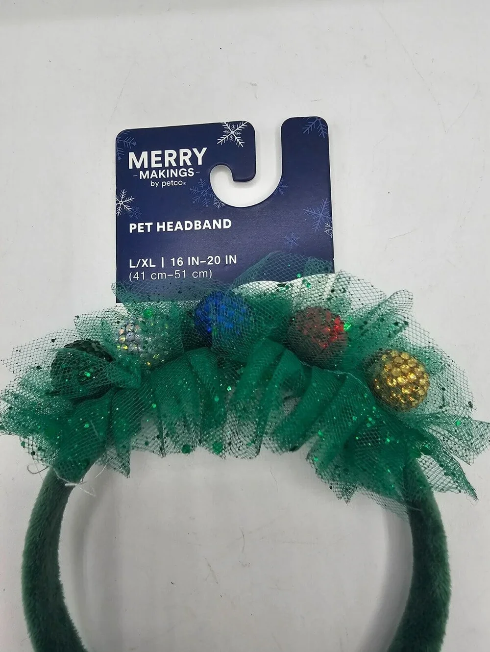 Merry Makings green pet headband adorned with tinsel and small ornaments